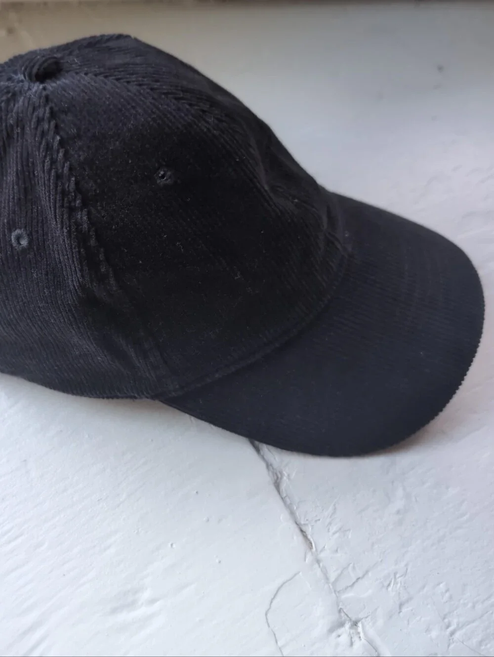 Black corduroy baseball cap with adjustable strap